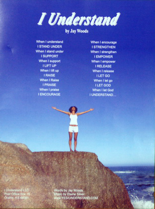 A woman standing on top of a cliff with her arms spread out.